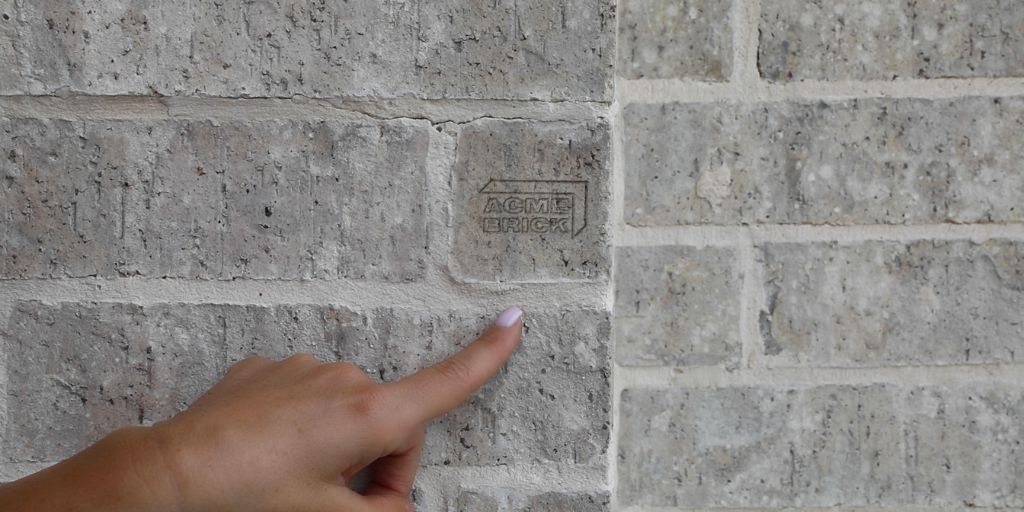 close up acme brick logo on a brick