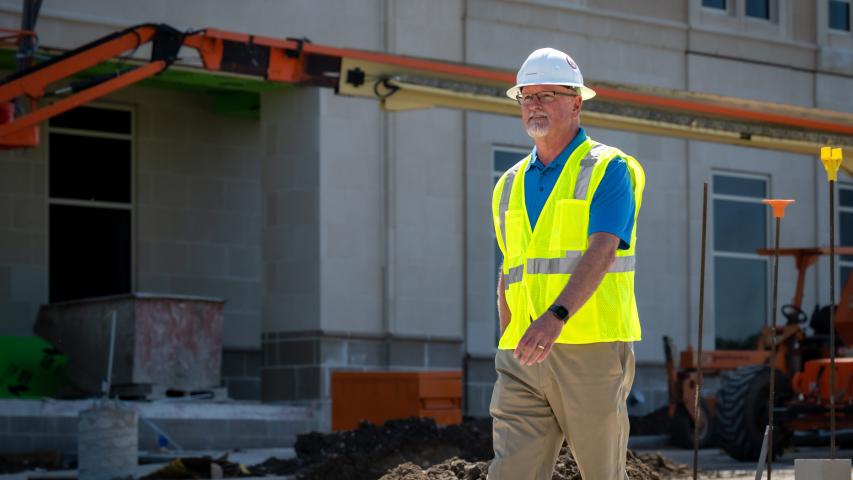 John Brewer of Acme Brick walking around construction site