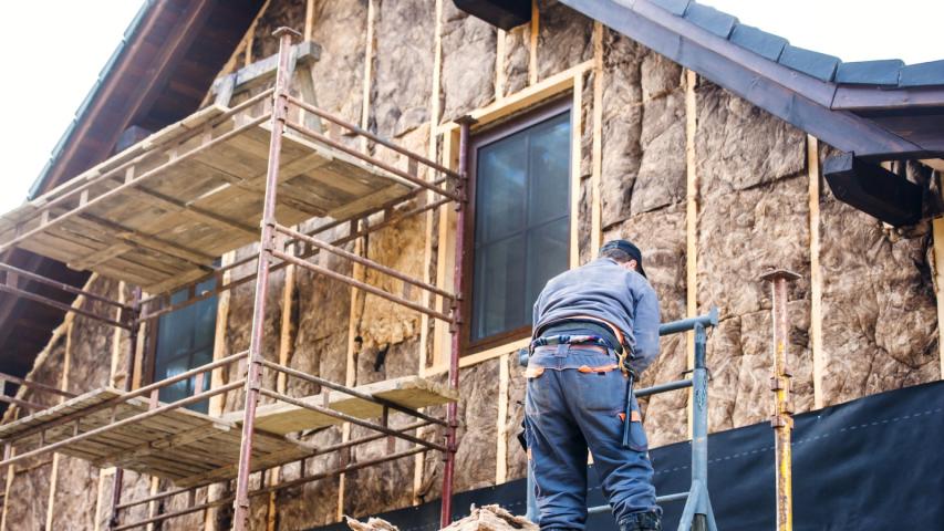 man working on home exterior